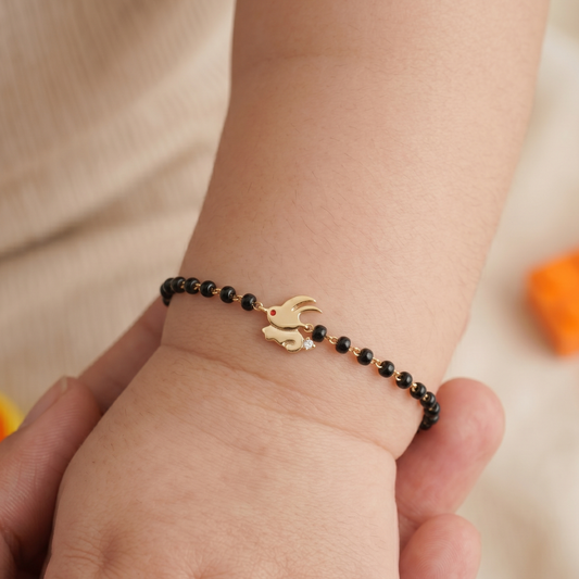 Baby wearing bunny nazariya — 14k gold kids nazariya diamond bracelet with black beads