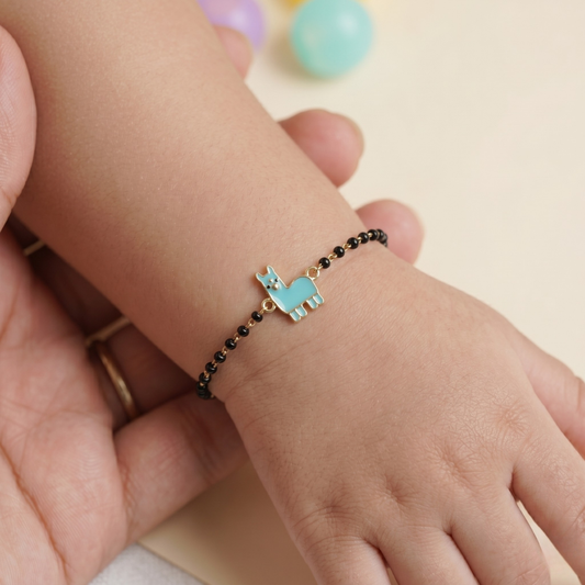 Nazariya worn on child’s wrist — 14k gold llama kids nazariya with black beads