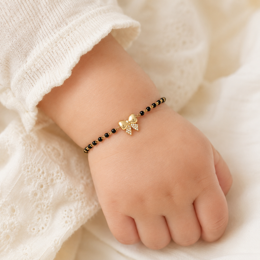 Baby wrist wearing bracelet — 14k gold bow kids nazariya with diamond bow charm