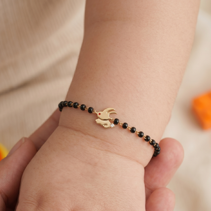 Baby wearing bunny nazariya — 14k gold kids nazariya diamond bracelet with black beads