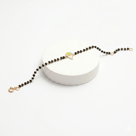 Hero shot on white stand — 14k gold ice cream kids nazariya with black beads