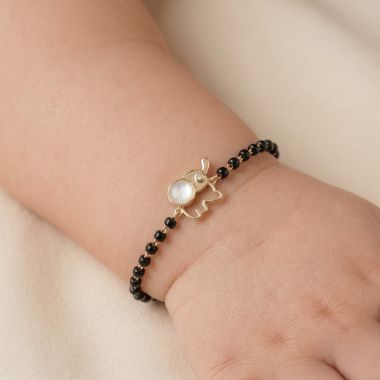 Child wearing mother of pearl kids nazariya — 14k gold diamond bracelet
