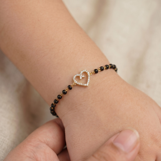 Child wearing bracelet — 14k gold kids nazariya black beads and diamond heart
