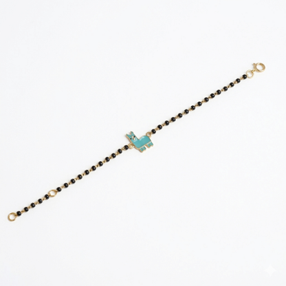 Full bracelet on white background — 14k gold llama kids nazariya with black beads