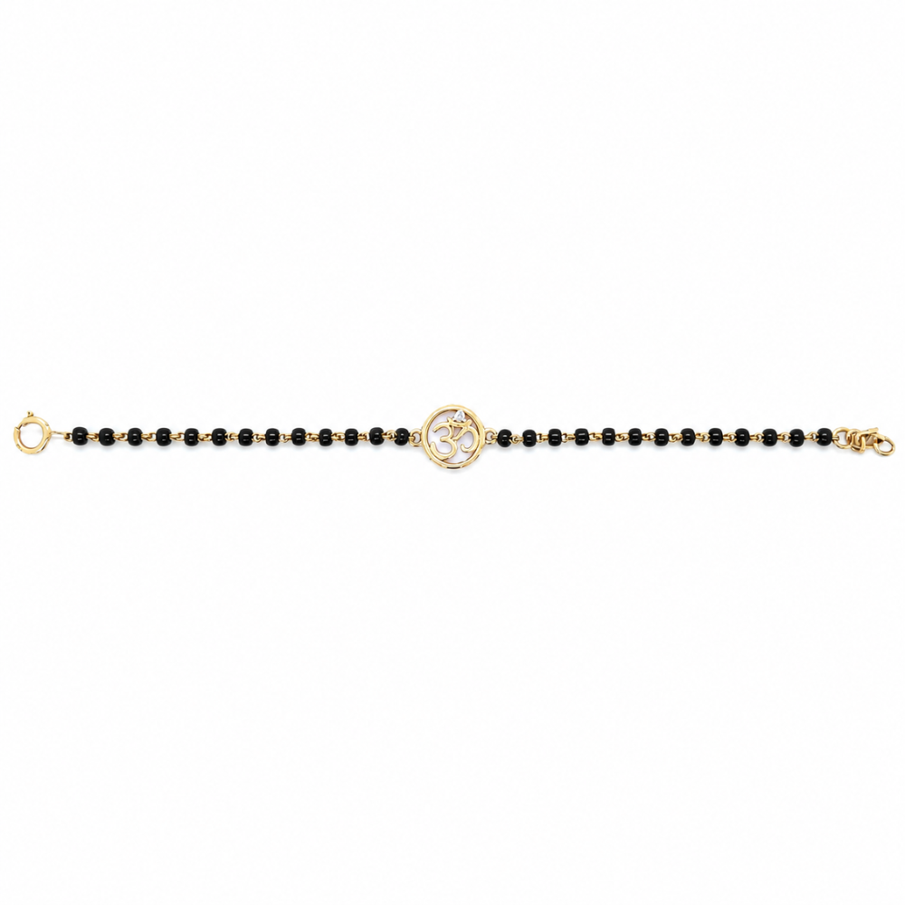 Front view on white background — 14k gold kids nazariya with Om charm and black beads