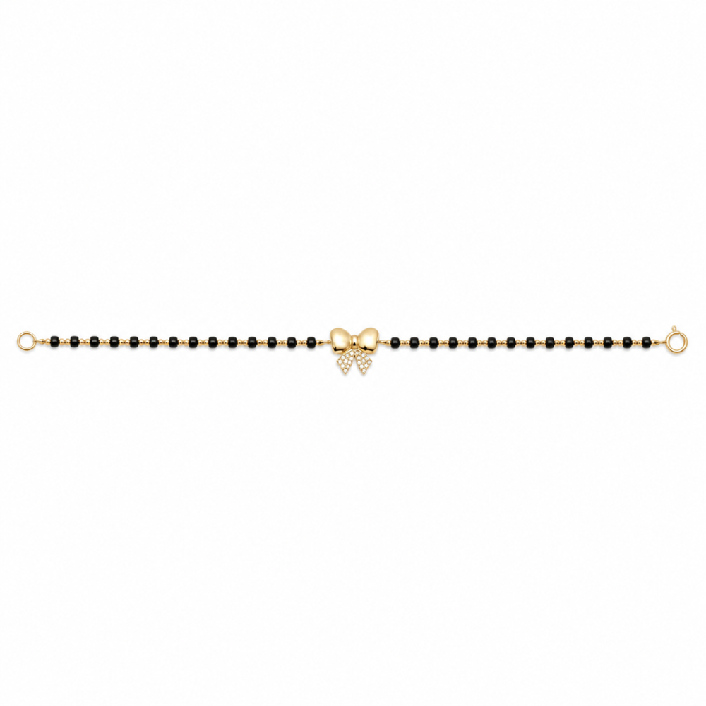 Front view of bow charm bracelet — 14k gold bow kids nazariya with black beads and diamonds
