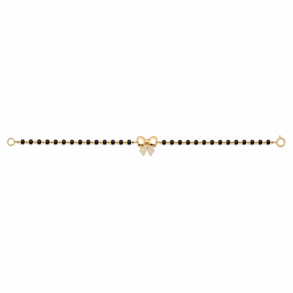 Front view of bow charm bracelet — 14k gold bow kids nazariya with black beads and diamonds