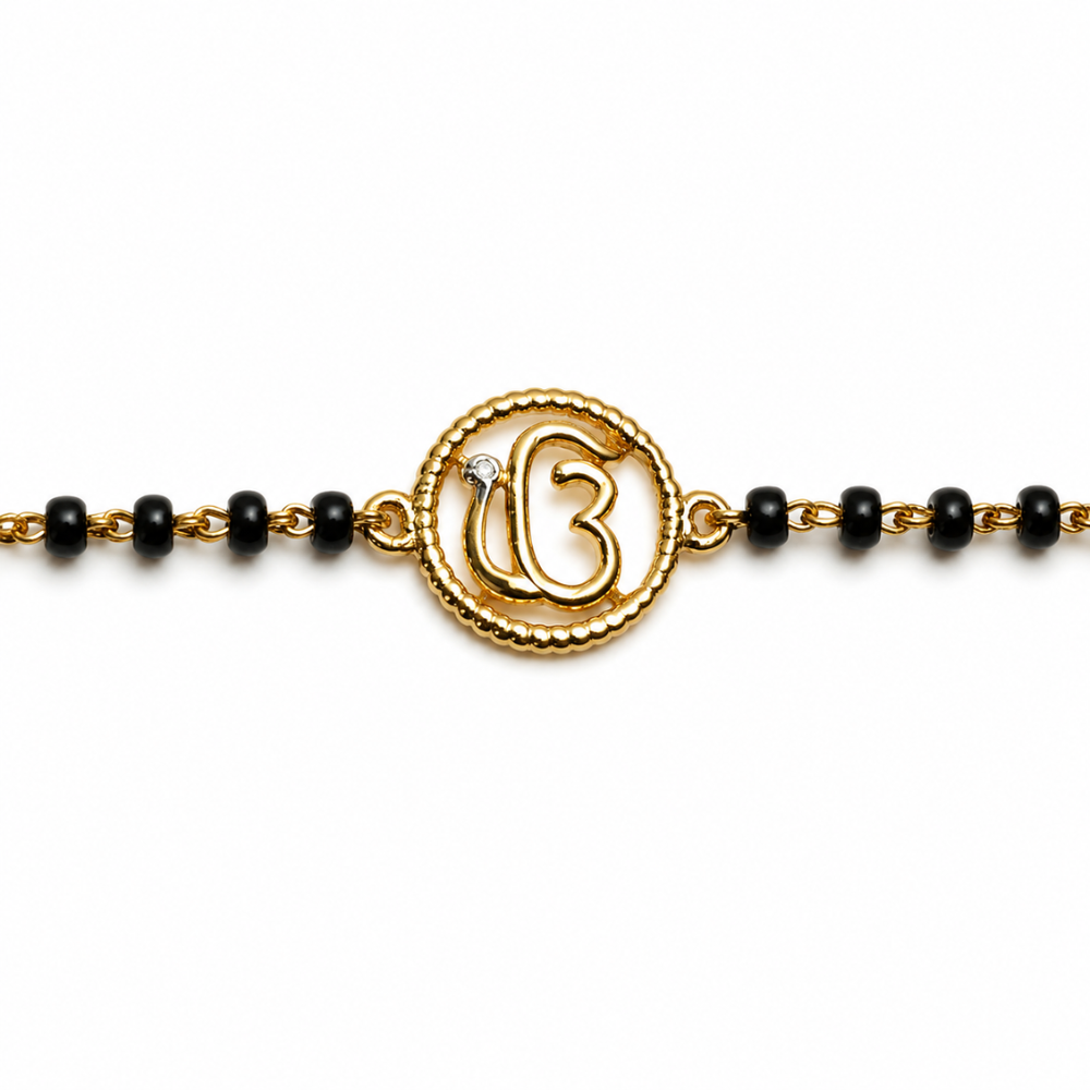 Close-up of Ik Onkar symbol — 14k gold kids nazariya with beaded round frame