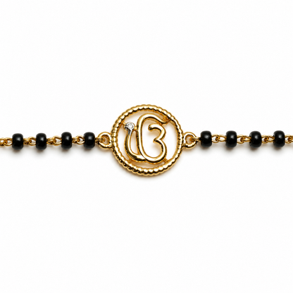 Close-up of Ik Onkar symbol — 14k gold kids nazariya with beaded round frame