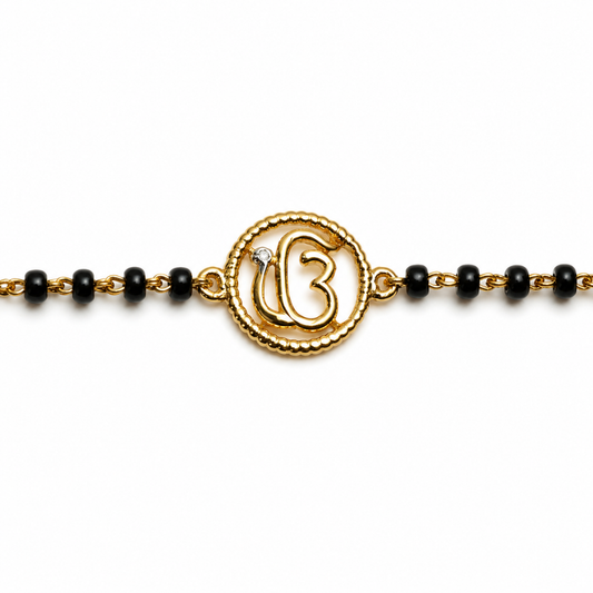 Close-up of Ik Onkar symbol — 14k gold kids nazariya with beaded round frame