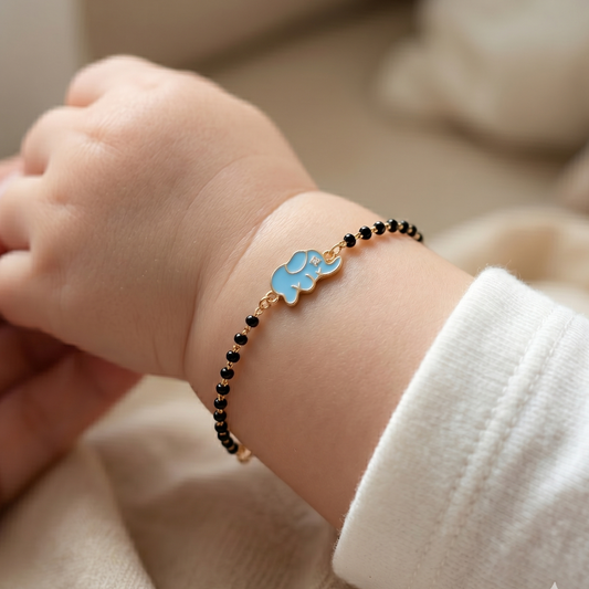 Baby wearing elephant nazariya — 14k gold kids nazariya diamond bracelet with black beads
