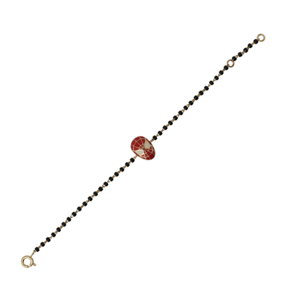 red enamel web mask charm on 14k gold kids nazariya bracelet with black beads