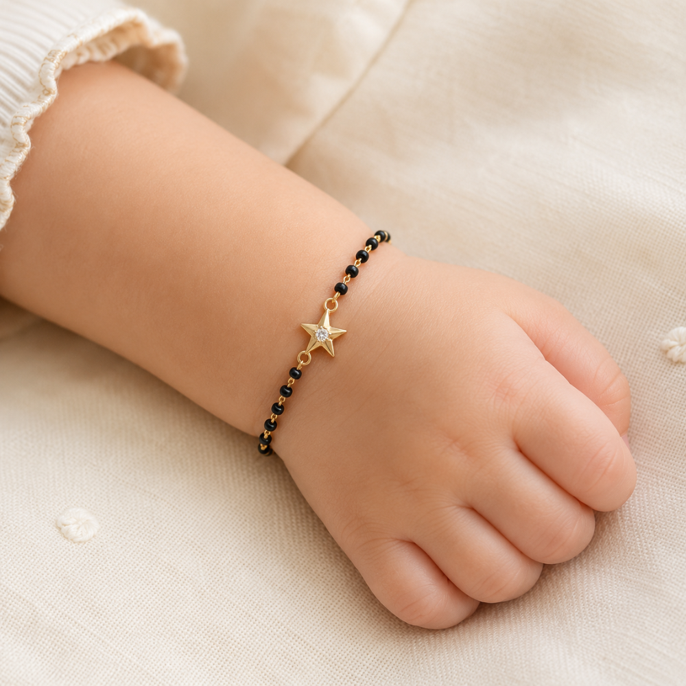 child wearing black bead bracelet — 14k gold star kids nazariya with diamond charm