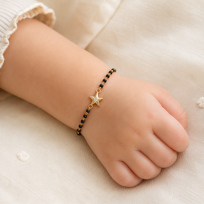 child wearing black bead bracelet — 14k gold star kids nazariya with diamond charm