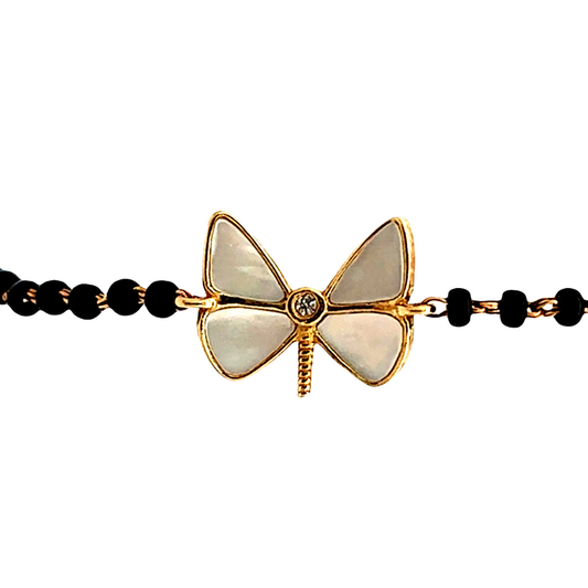 close-up of diamond at dragonfly centre — 14k gold kids nazariya with polished charm detail
