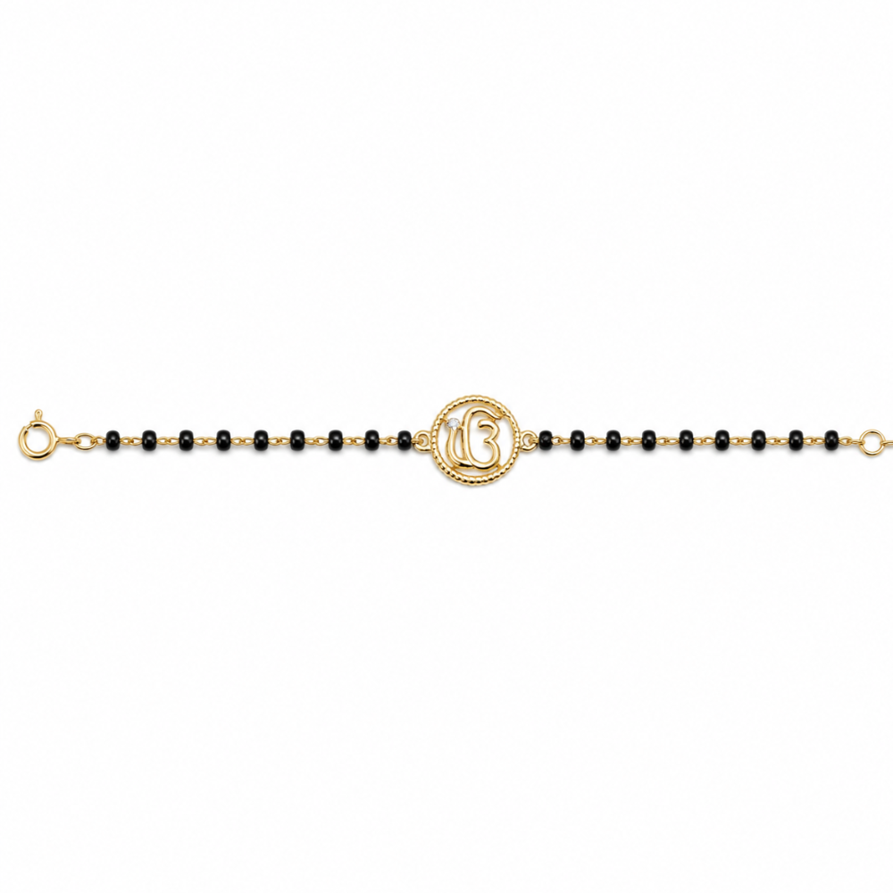 Front view of Ik Onkar charm — 14k gold kids nazariya with black beads