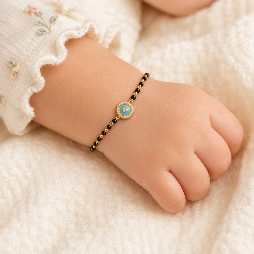 Worn on a child’s wrist — 14k gold kids nazariya black bead bracelet detail