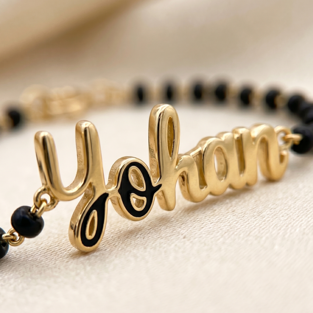 Custom baby name charm detail — 14k gold kids nazariya with personalised name